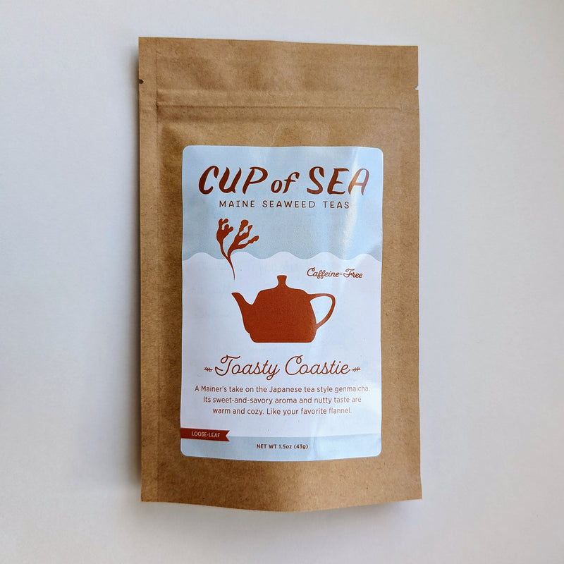 Stand-up pouch of tea featuring an illustration of a kettle with steam in the shape of seaweed. Label text says Cup of Sea, Maine seaweed teas, caffeine-free, Toasty Coastie, A Mainer&